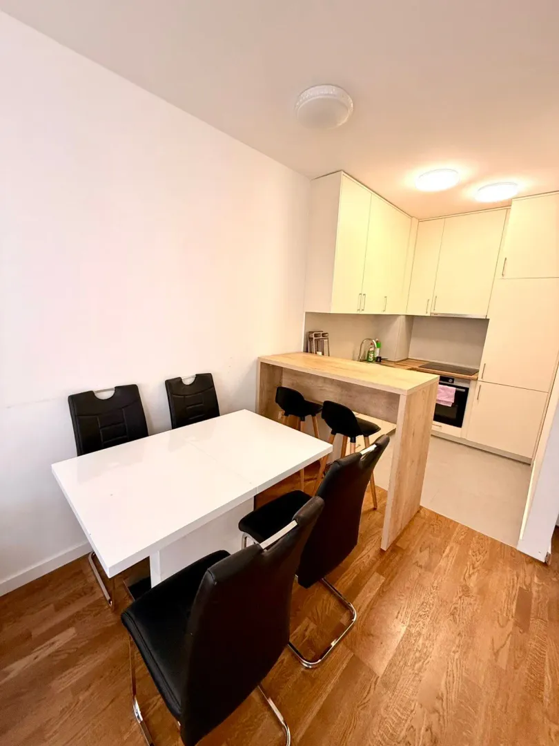 Bright kitchen featuring a dining table and a breakfast bar.