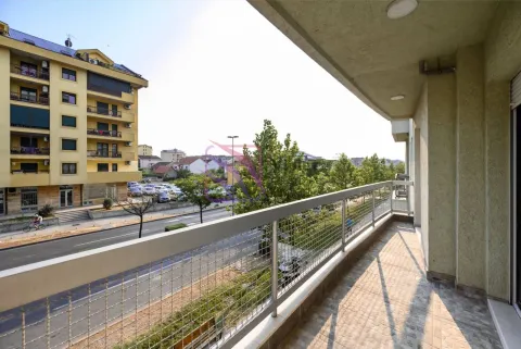 Spacious tiled balcony with a metal railing and a view of the street and surrounding buildings. - image 2