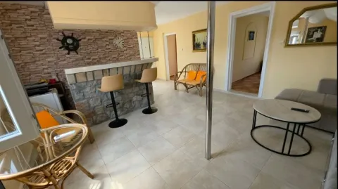 Living room with a bar counter and dining area. - image 7