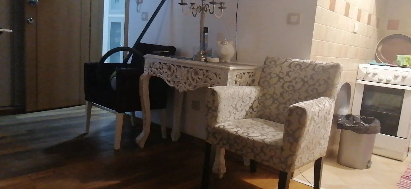 Part of a room with armchairs, a decorative table, and a stove.