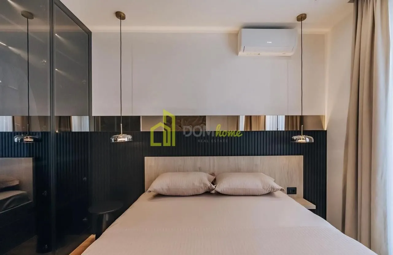Modern bedroom with a double bed and a fitted wardrobe.