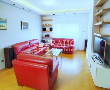 Living room with red leather sofas and wooden shelves. - image 6