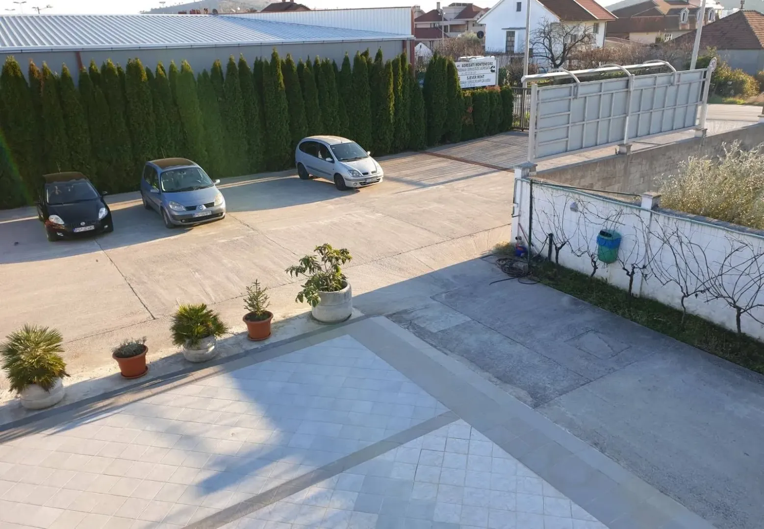 Paved yard and parking area in front of the building.