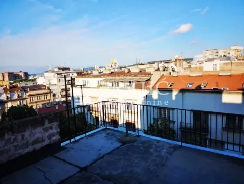 Open terrace with a metal railing and a city view. - image 11