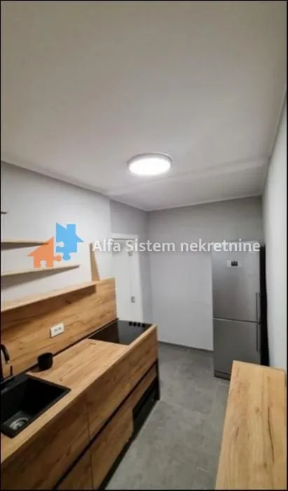 View of a modernly equipped kitchen with wooden elements.