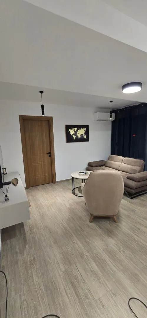 Modern and tidy living room with sofa set and wooden doors.