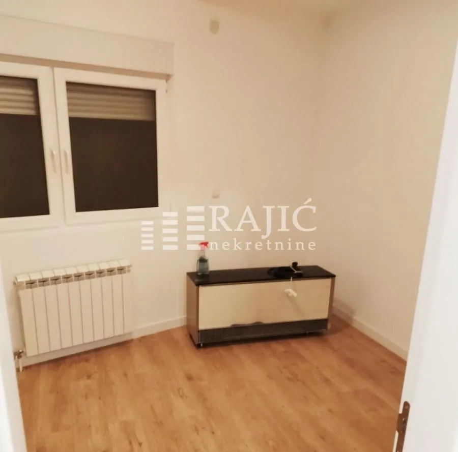 Empty room with laminate flooring and a window.