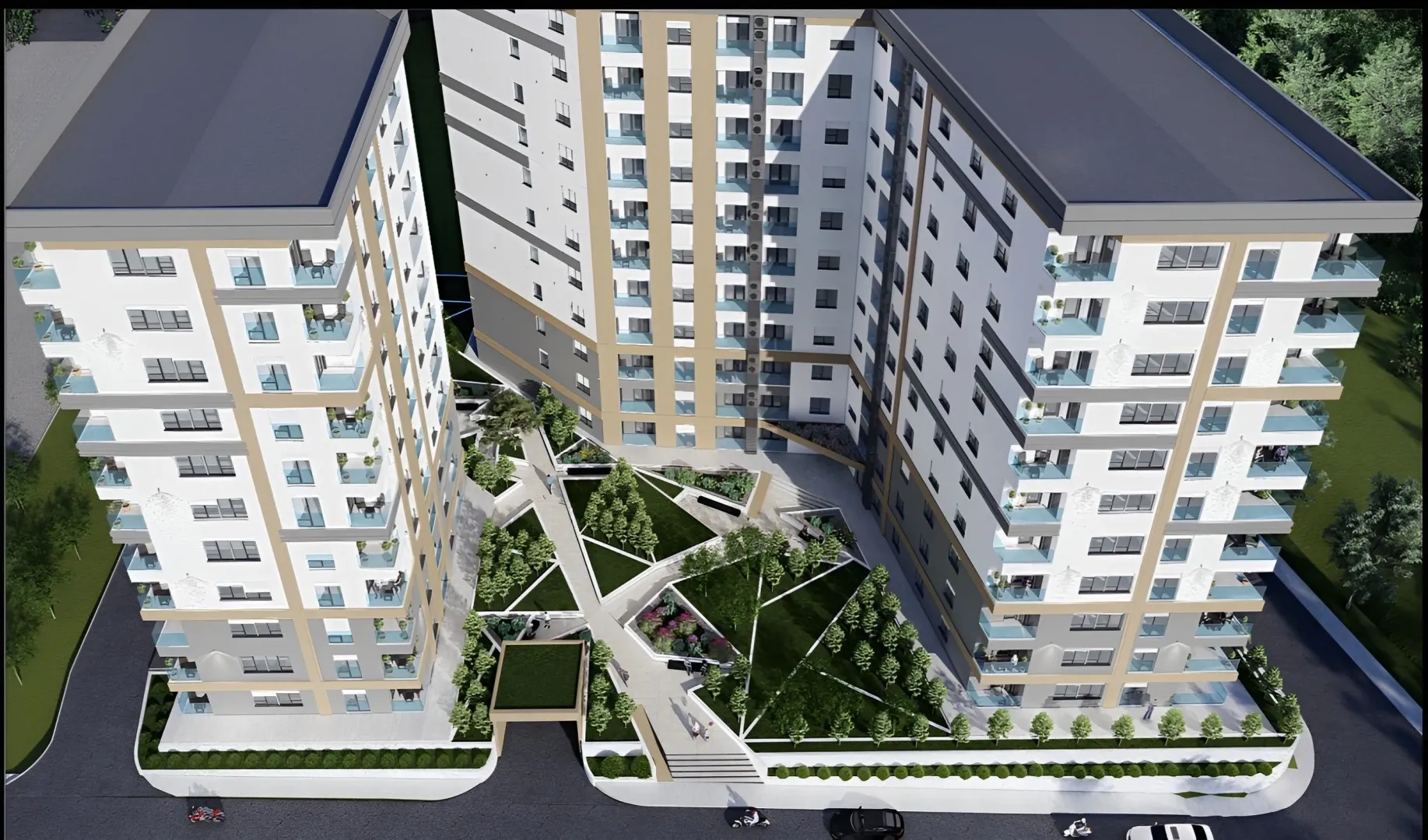Pogled iz vazduha na spoljašnjost stambene zgrade sa uređenim dvorištem.