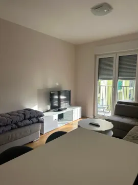 Living room with furniture, television, and access to the terrace. - image 2