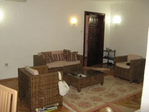 Living room featuring wicker furniture, a rug, and a coffee table. - image 15