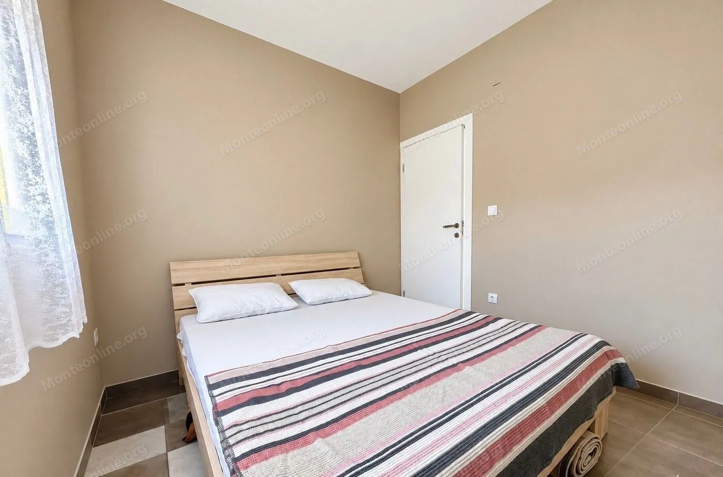 Small bedroom with a double bed.