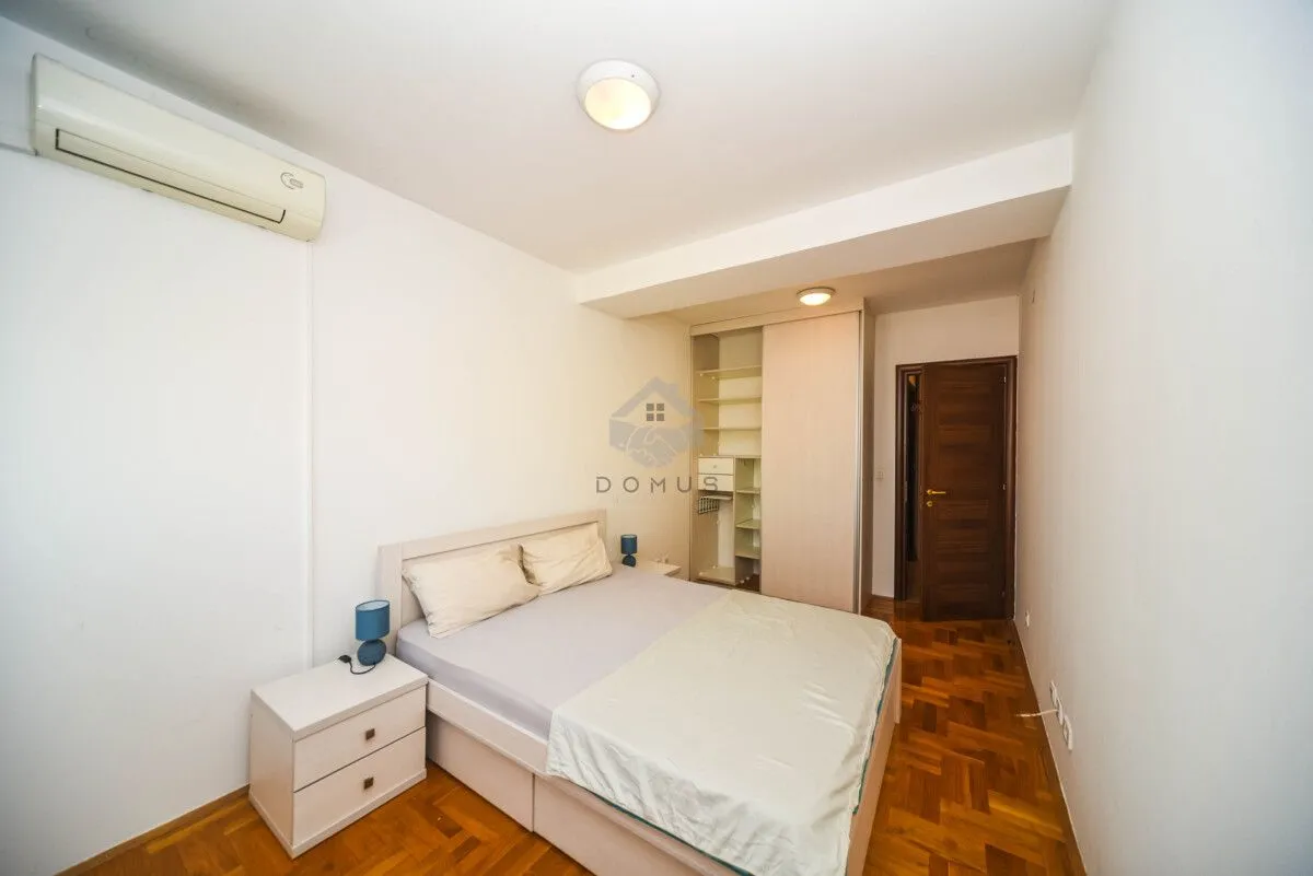 Bedroom with a double bed, bedside table, and built-in wardrobe.