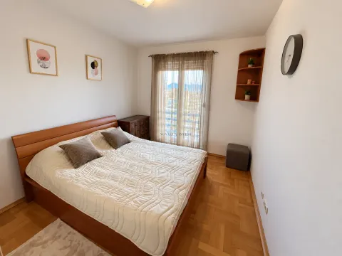 Furnished bedroom with a double bed, wooden flooring, and a window overlooking the terrace. - image 6