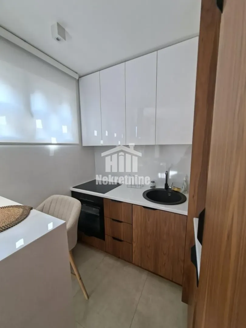 Modern kitchen with white and wooden elements.
