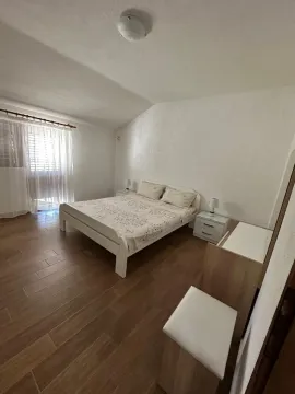 Furnished bedroom with a double bed, nightstands, and a window. - image 7