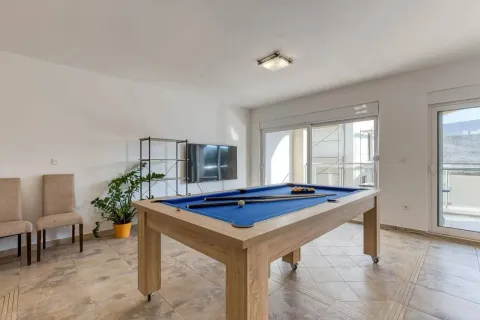 Spacious living room with a pool table and access to the terrace. - image 2