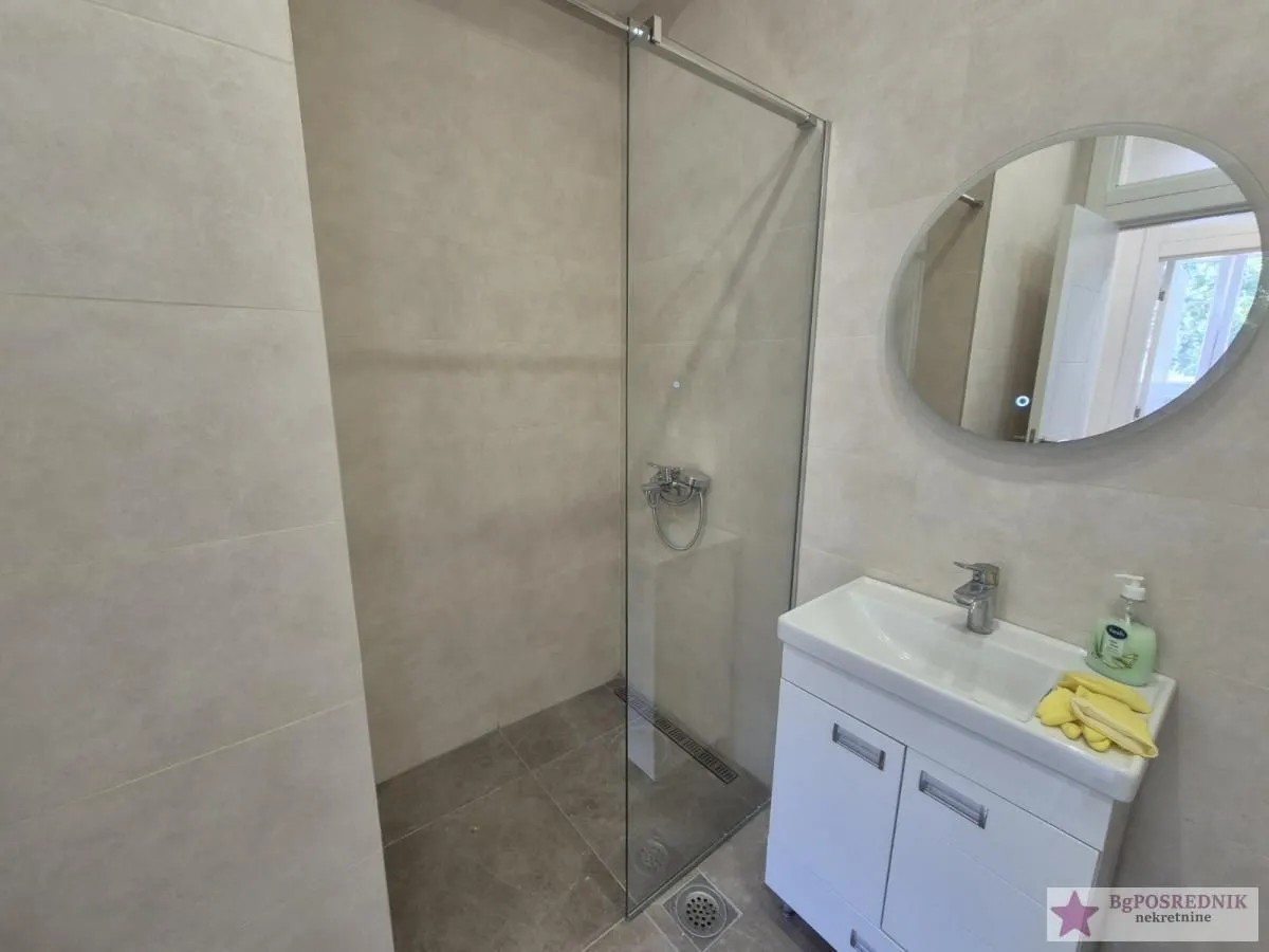 Modern bathroom with a walk-in shower and a vanity unit.
