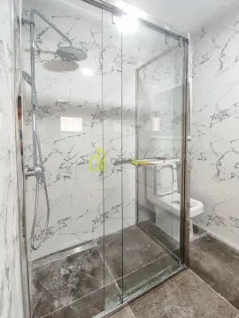 Modern bathroom with a walk-in shower lined with marble-patterned tiles. - image 8