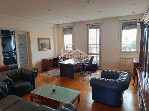 Spacious living room with seating set and a desk. - image 12
