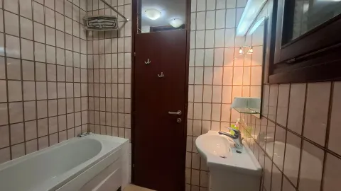 Manje kupatilo sa kadom, umivaonikom i pločicama na zidovima. - image 13