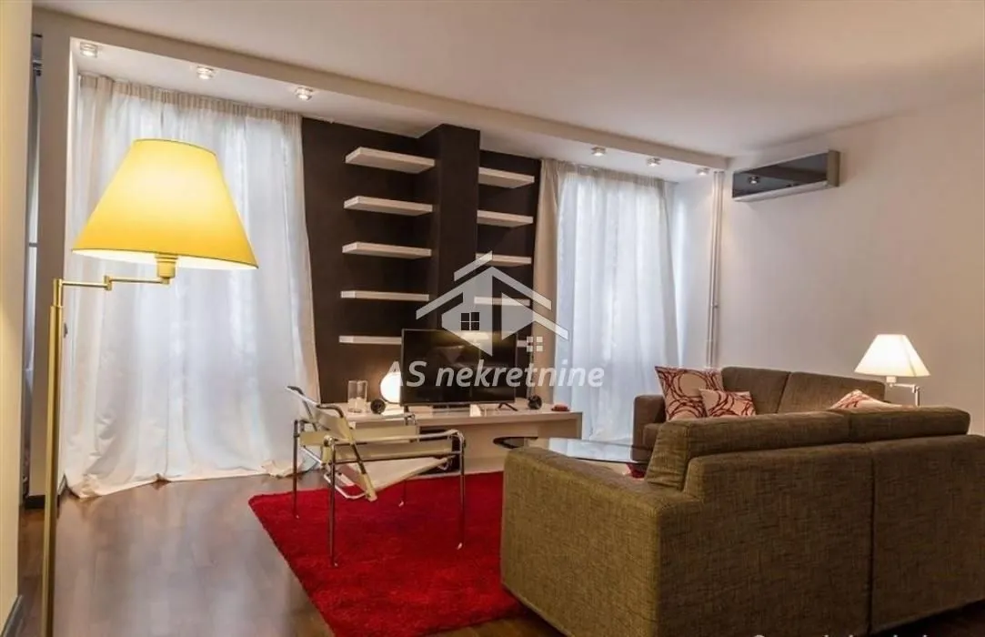 Comfortable living room with sofa set and decorative wall.