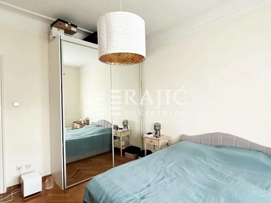 Bedroom with a bed and a large mirrored wardrobe.