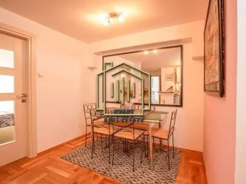 Dining area with a table, chairs, and a wall mirror. - image 5