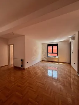 Empty room with parquet flooring and a single window. - image 9