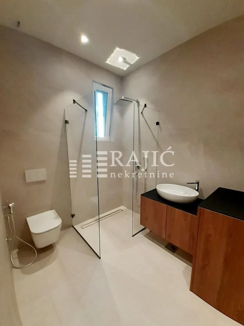 Modern equipped bathroom with a walk-in shower.