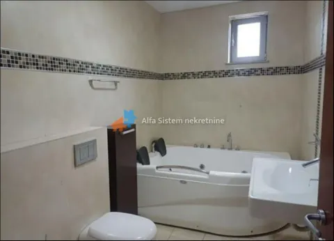 Bathroom equipped with a bathtub, washbasin, and toilet. - image 20