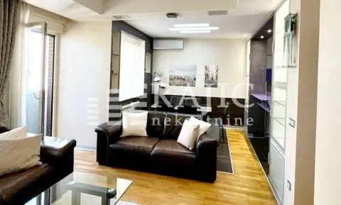 Living room with a sofa and parquet flooring. - image 4