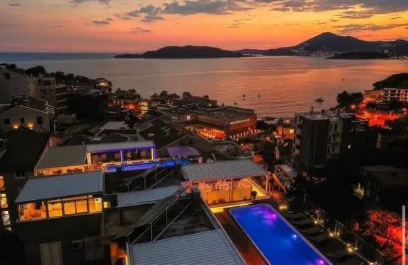 View from the terrace towards the town and the sea at dusk.