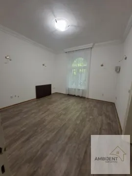 Empty room with laminate flooring and white walls. - image 6
