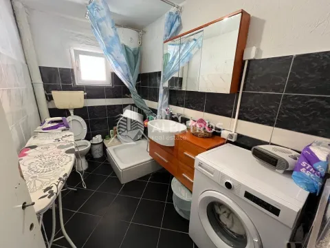Bathroom equipped with sanitary fixtures, a shower cabin, and a washing machine. - image 10