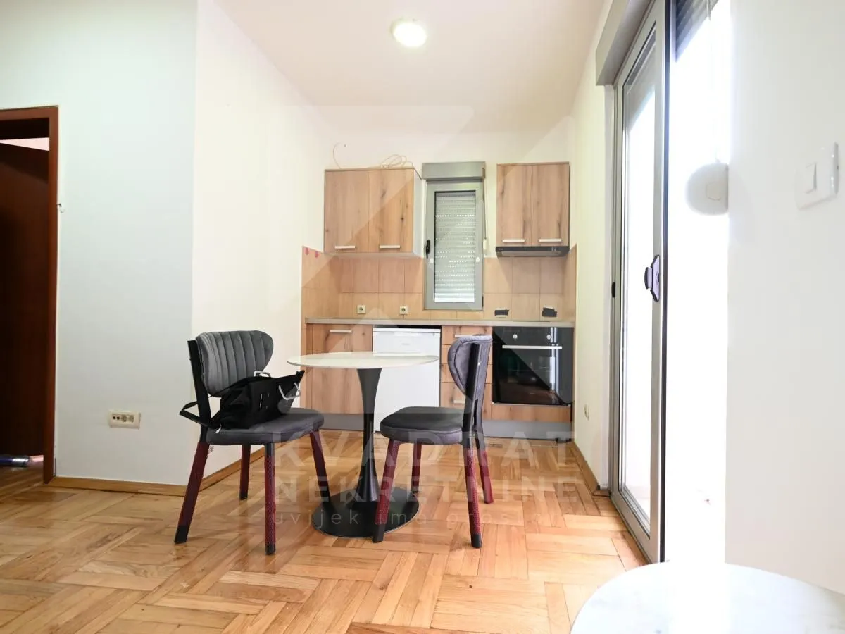 Small kitchen with a dining table and chairs.