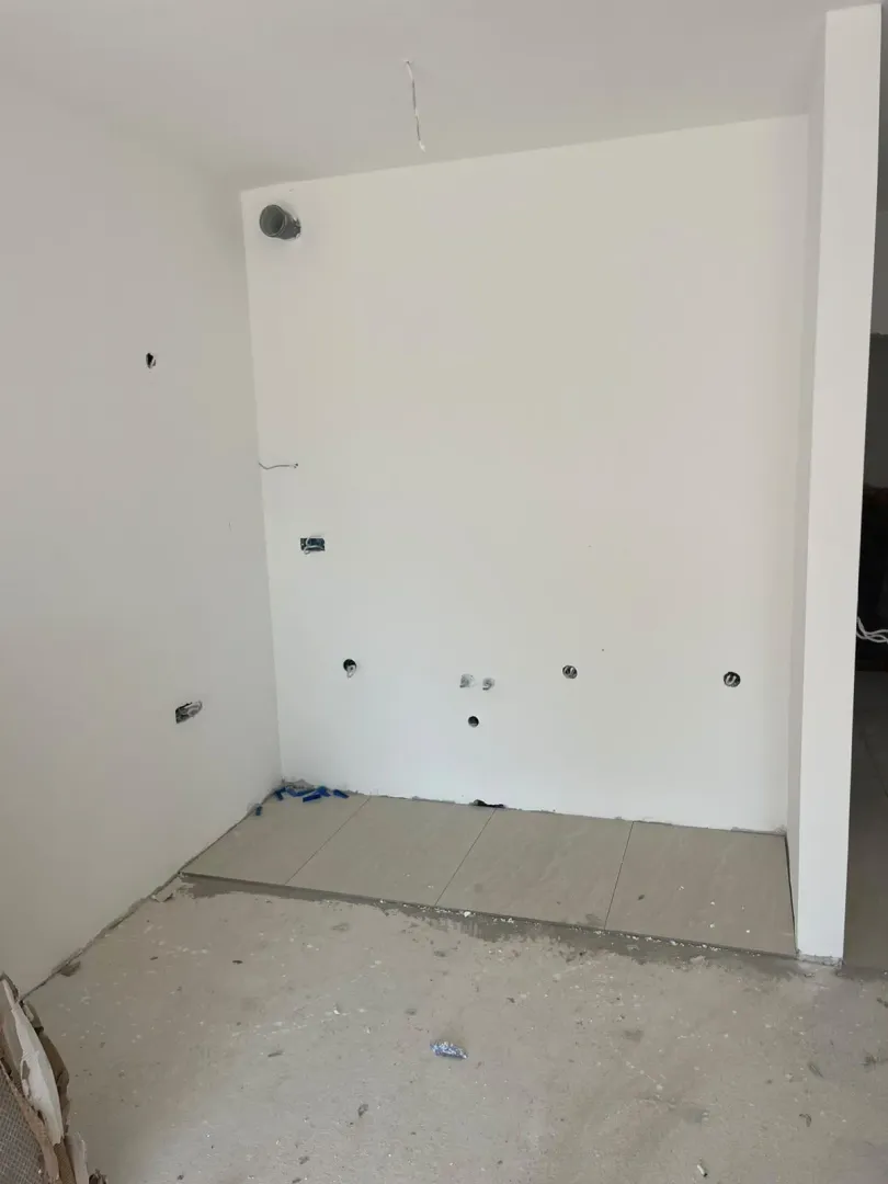 Prostor u fazi renoviranja sa postavljenim pločicama i zidovima pripremljenim za završnu obradu.
