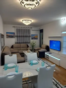Bright living room with a dining table and a seating area. - image 4