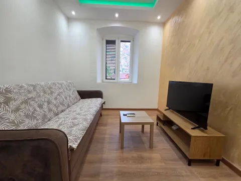 Living room with sofa, coffee table, and TV. - image 2