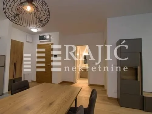 Interior of the apartment with a dining table and chairs.