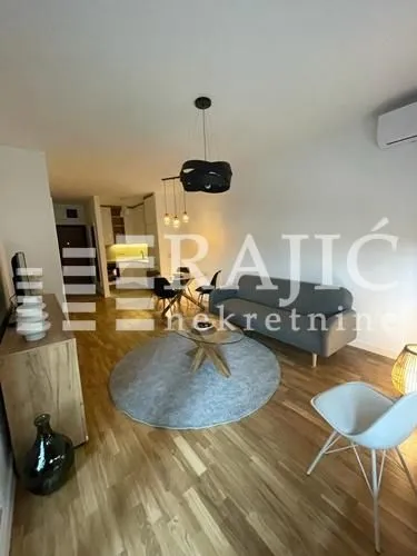 Living room with sofa and dining area.