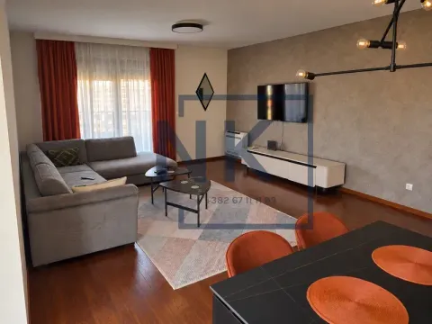 Spacious living room with a sectional sofa, TV, and dining table. - image 5