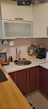 Small kitchen with a sink, countertop and wall cabinets. - image 4