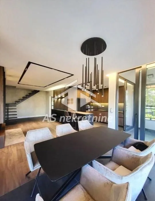Living room with dining area and staircase.