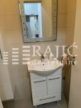 Small bathroom with a sink and a mirror. - image 17