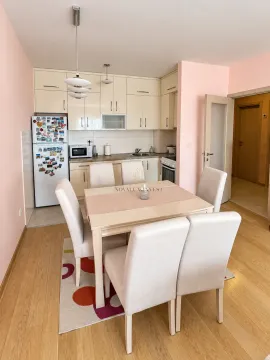 Kitchen with a dining area and light wooden cabinetry. - image 3