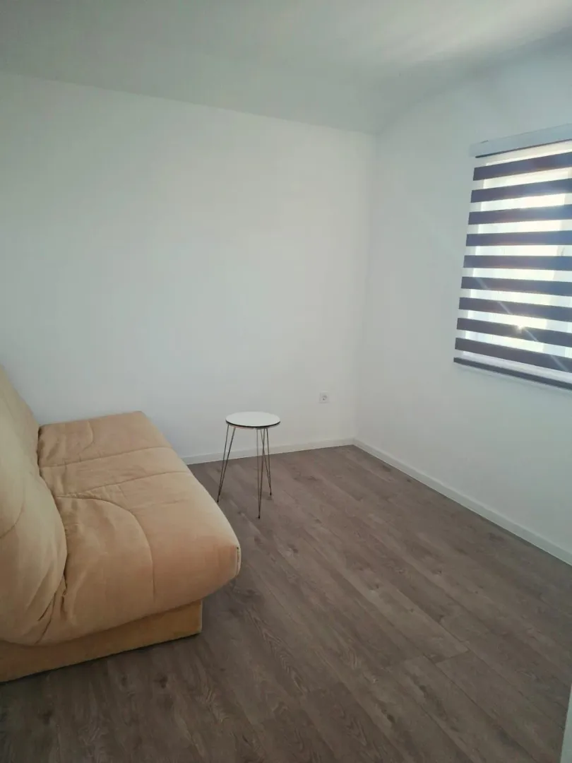 Small bright living room with a sofa and a small coffee table.