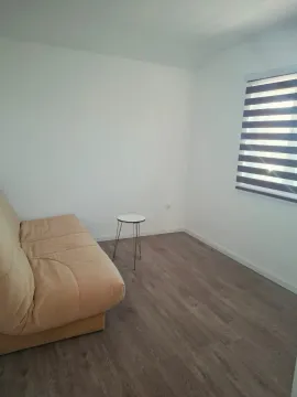 Small bright living room with a sofa and a small coffee table. - image 4