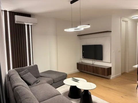 Modern and bright living room with a sectional sofa and TV unit. - image 3