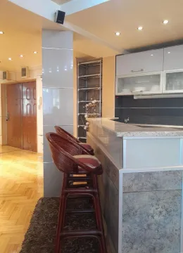 Kitchen with a breakfast bar and bar stools. - image 12