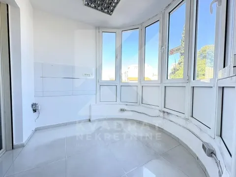 Enclosed balcony with bright walls and tiled flooring. - image 3